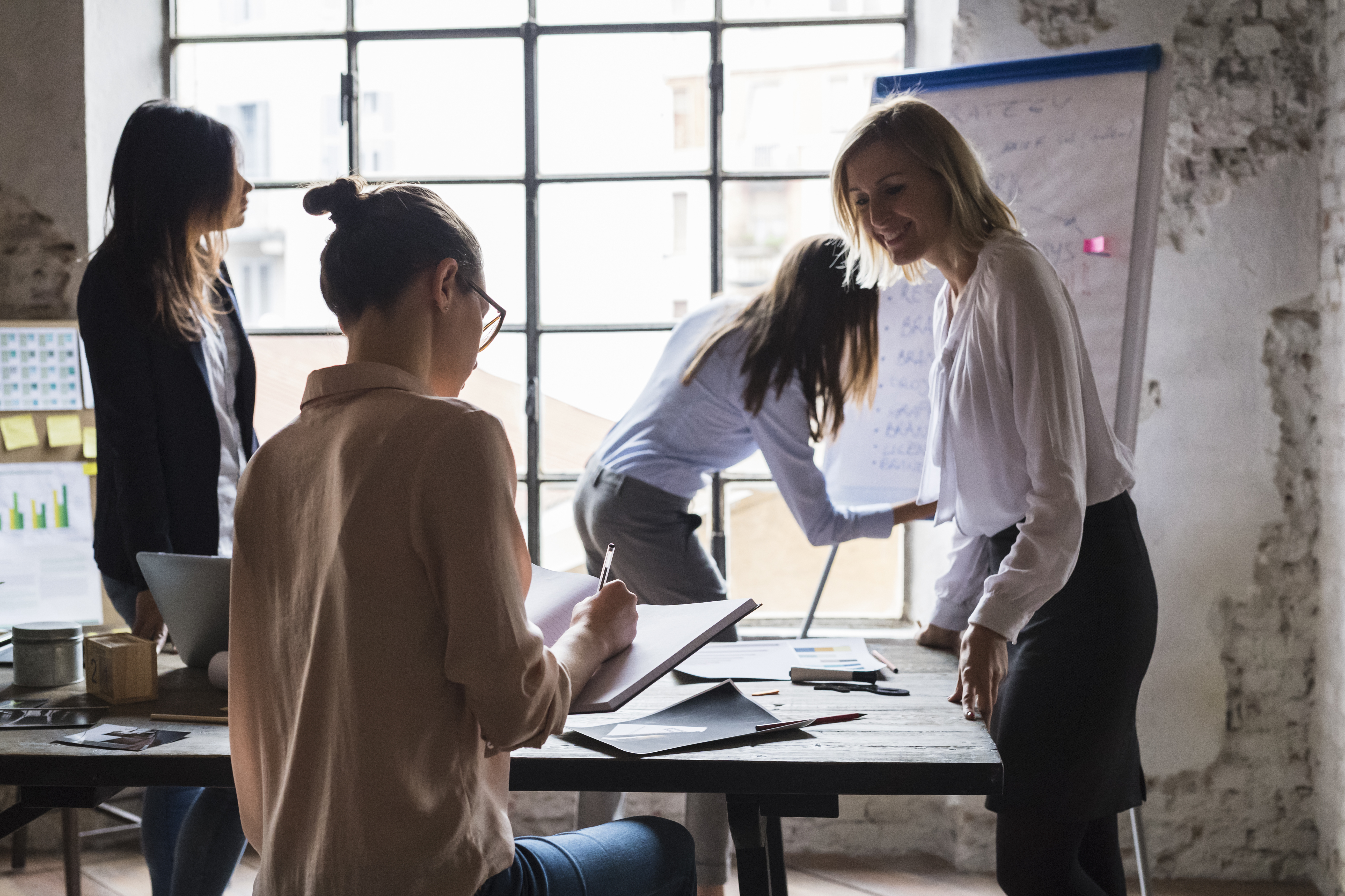 Group of businesswomen during a meeting in a modern space.